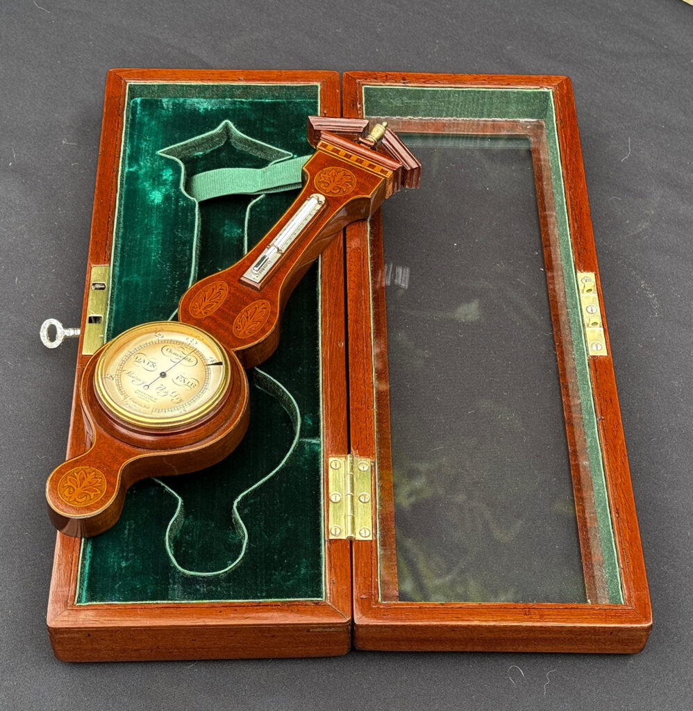 Full right side view of an Antique Salesman Sample Miniature 9.5” Barometer partially removed from its display case.