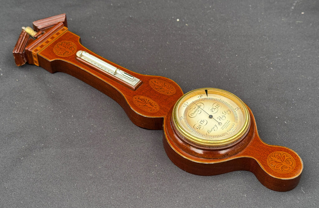 Full left view of an Antique Salesman Sample Miniature 9.5” Barometer out of its display case.