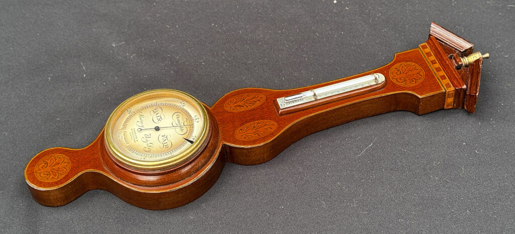 Full right view of an Antique Salesman Sample Miniature 9.5” Barometer out of its display case.
