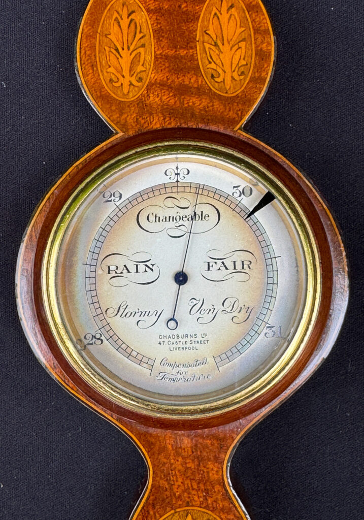 Close up view of the main dial from an Antique Salesman Sample Miniature 9.5” Barometer.