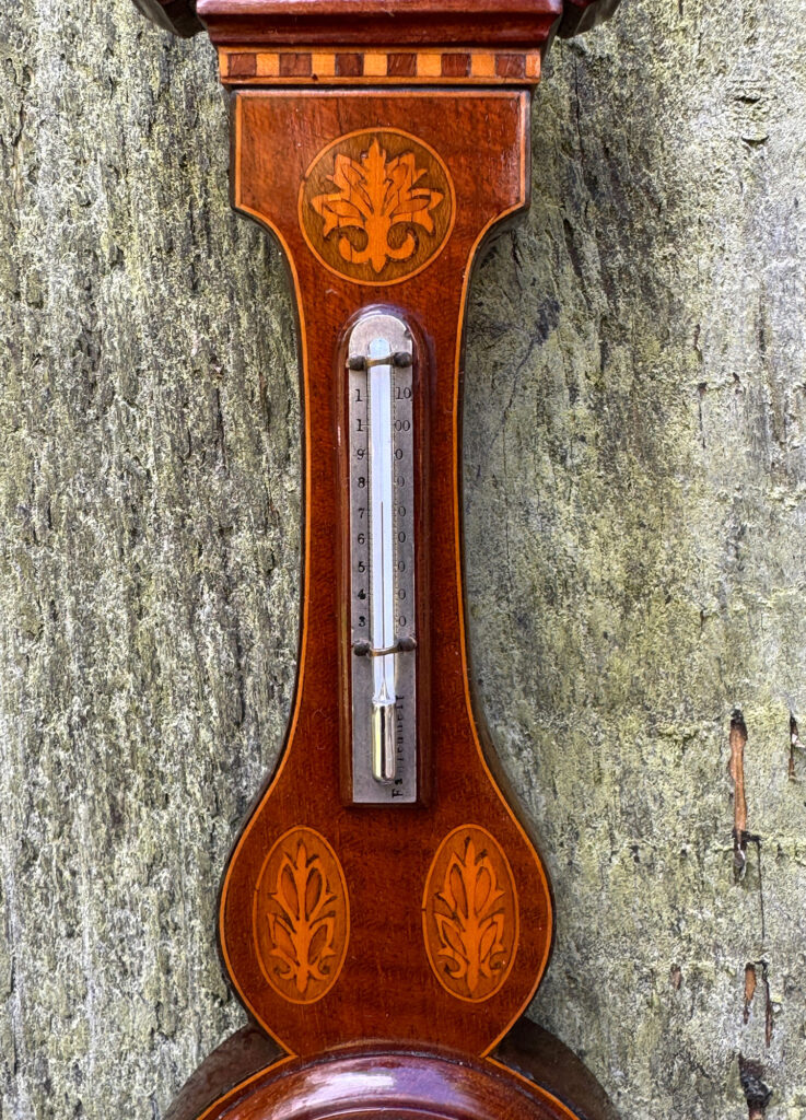 Semi-close up view of the thermometer dial from an Antique Salesman Sample Miniature 9.5” Barometer.