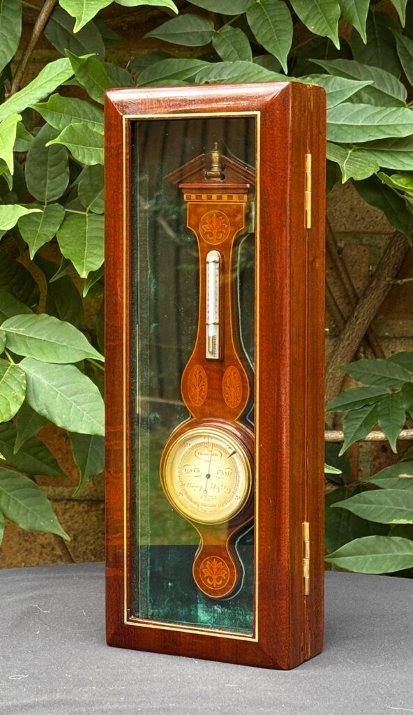 Full standing view of an Antique Salesman Sample Miniature 9.5” Barometer fitted within its display case.