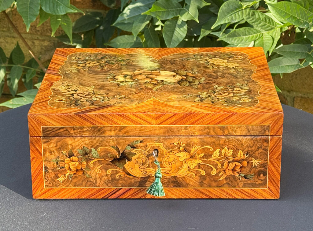 Front view of an antique Georgian jewellery box in burr walnut & kingwood with floral marquetry inlay.