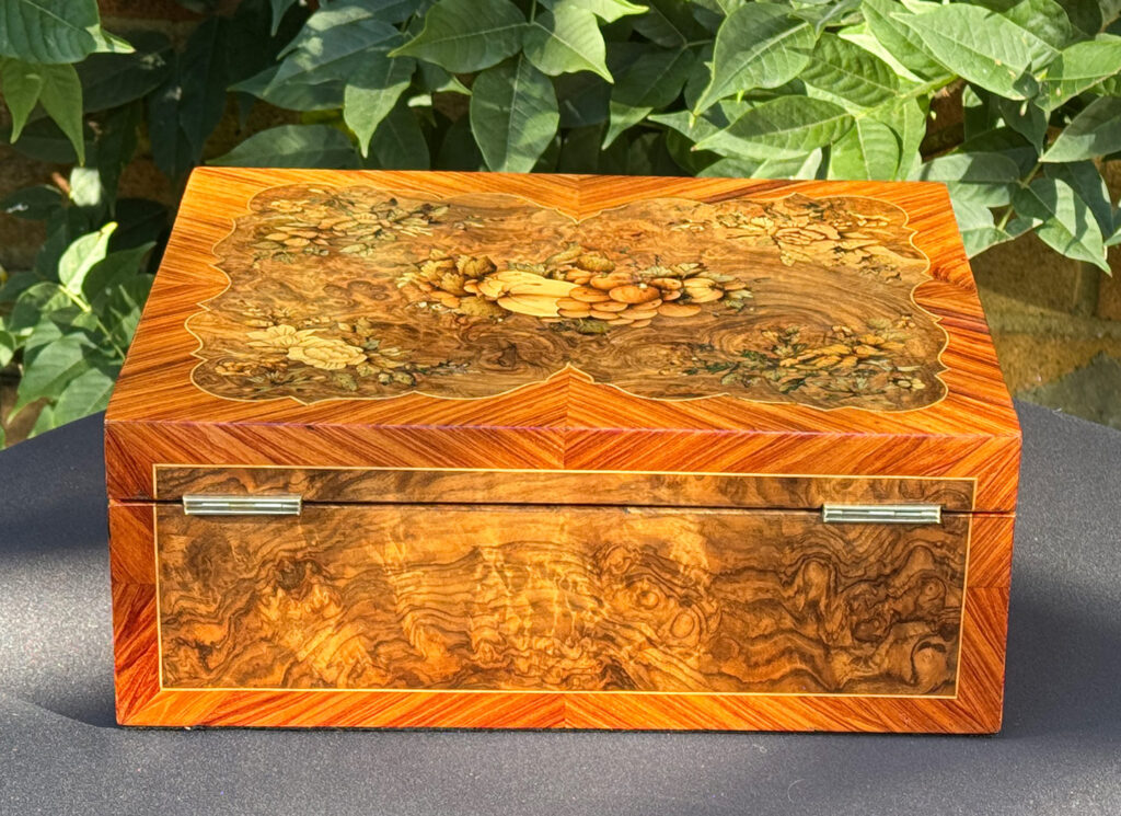 Rear view of an antique Georgian jewellery box in burr walnut & kingwood with floral marquetry inlay.