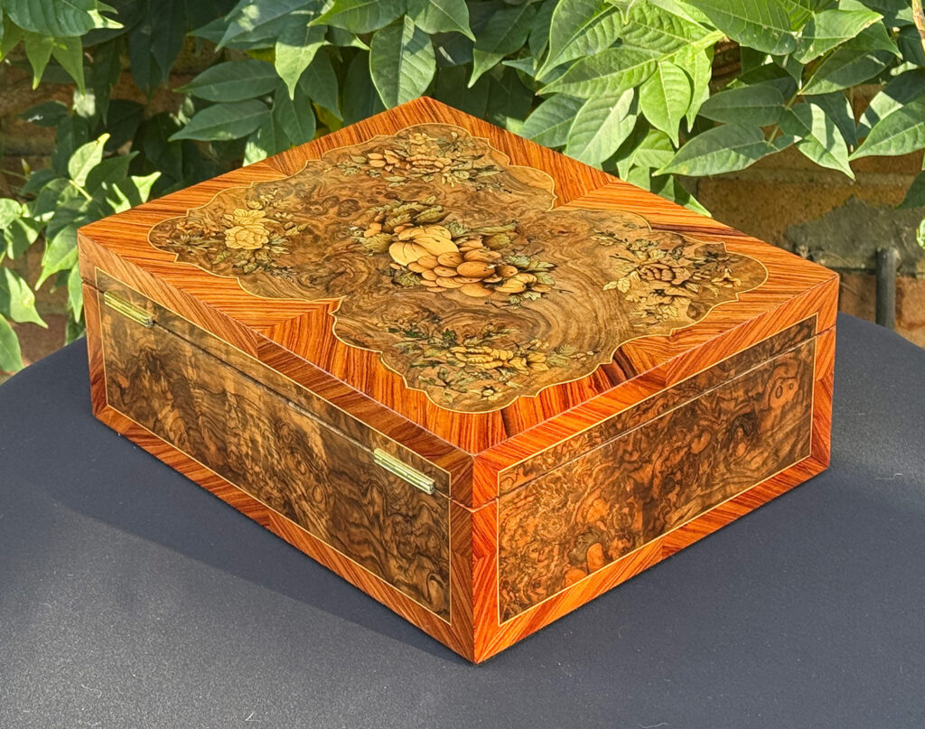 Rear left view of an antique Georgian jewellery box in burr walnut & kingwood with floral marquetry inlay.