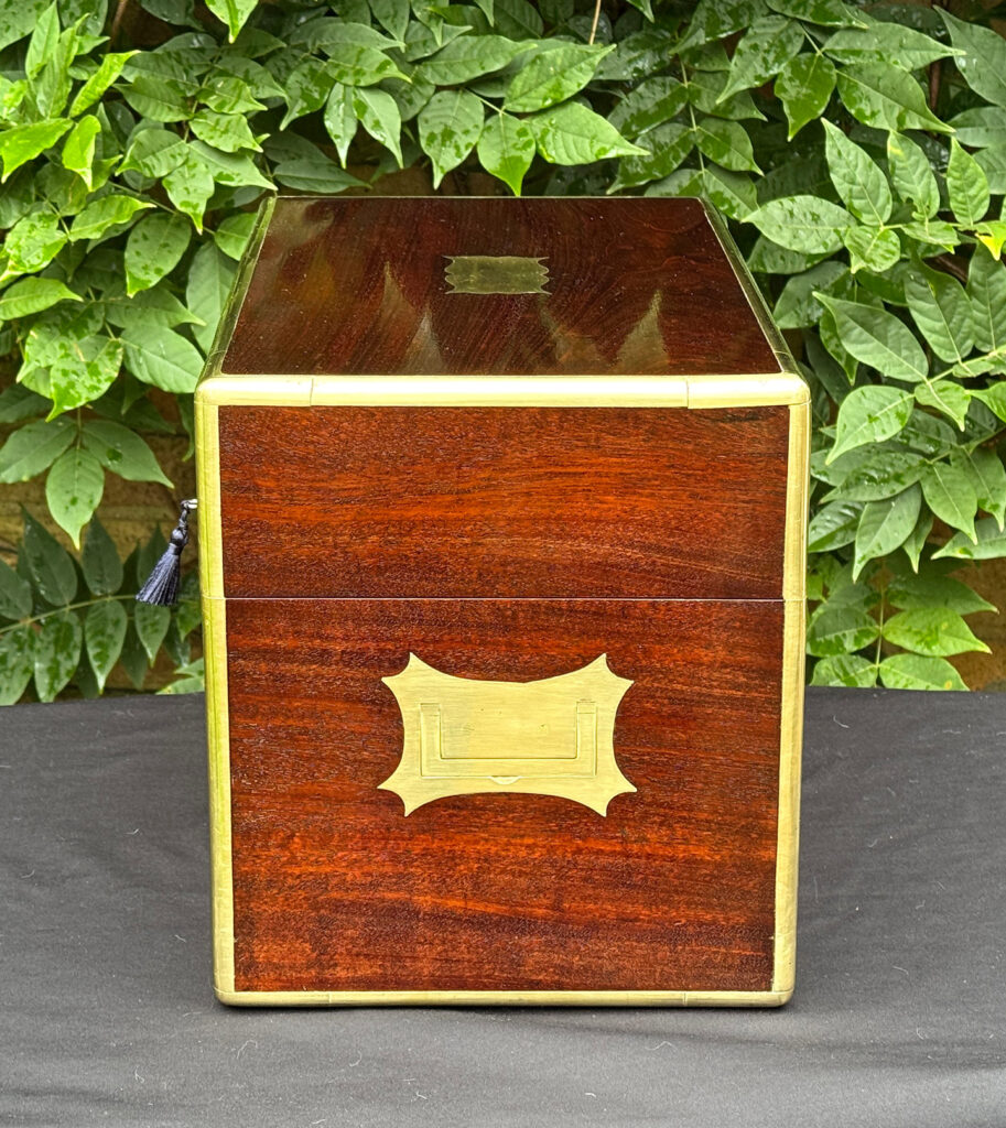 Left side view of a large antique gentleman’s travelling jewellery box in Cuban mahogany.