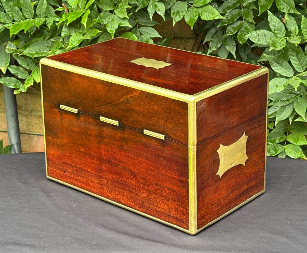 Rear left view of a large antique gentleman’s travelling jewellery box in Cuban mahogany.