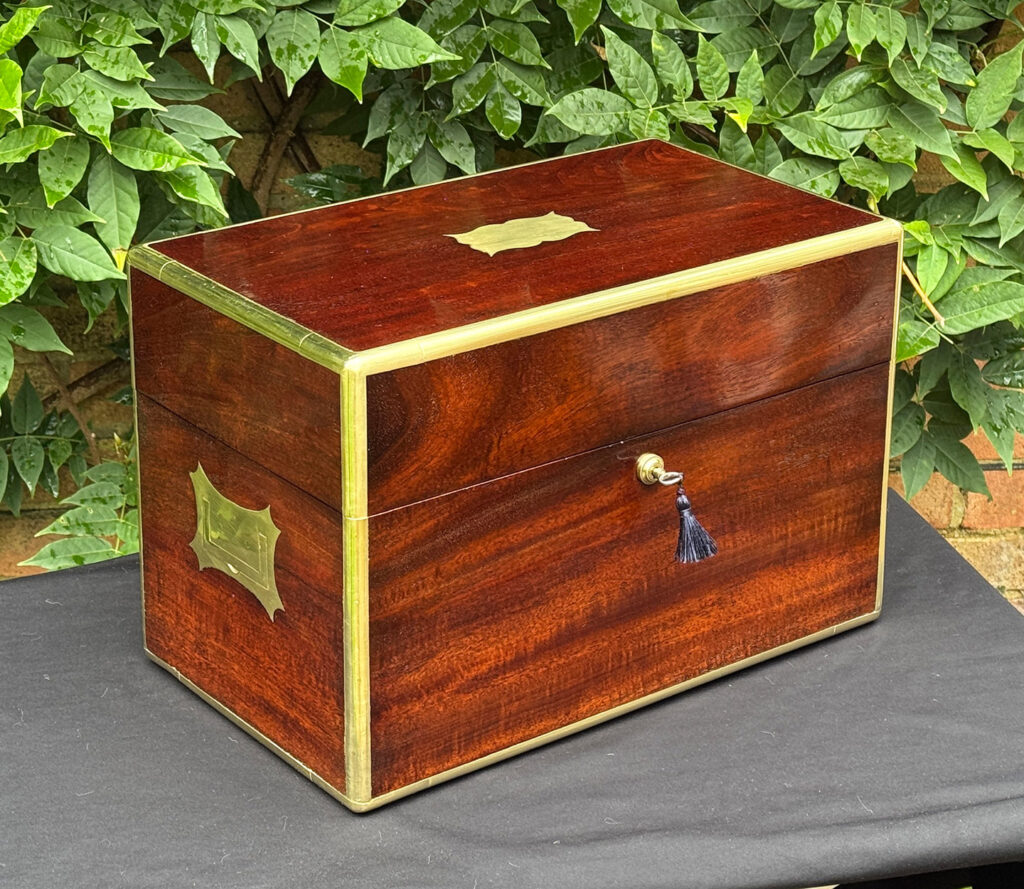 Front left view of a large antique gentleman’s travelling jewellery box in Cuban mahogany.