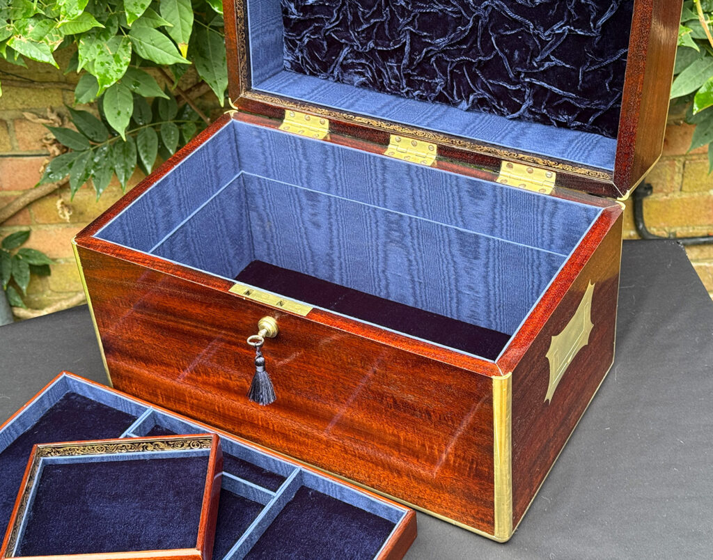 View of the base compartment from a large antique gentleman’s travelling jewellery box in Cuban mahogany.