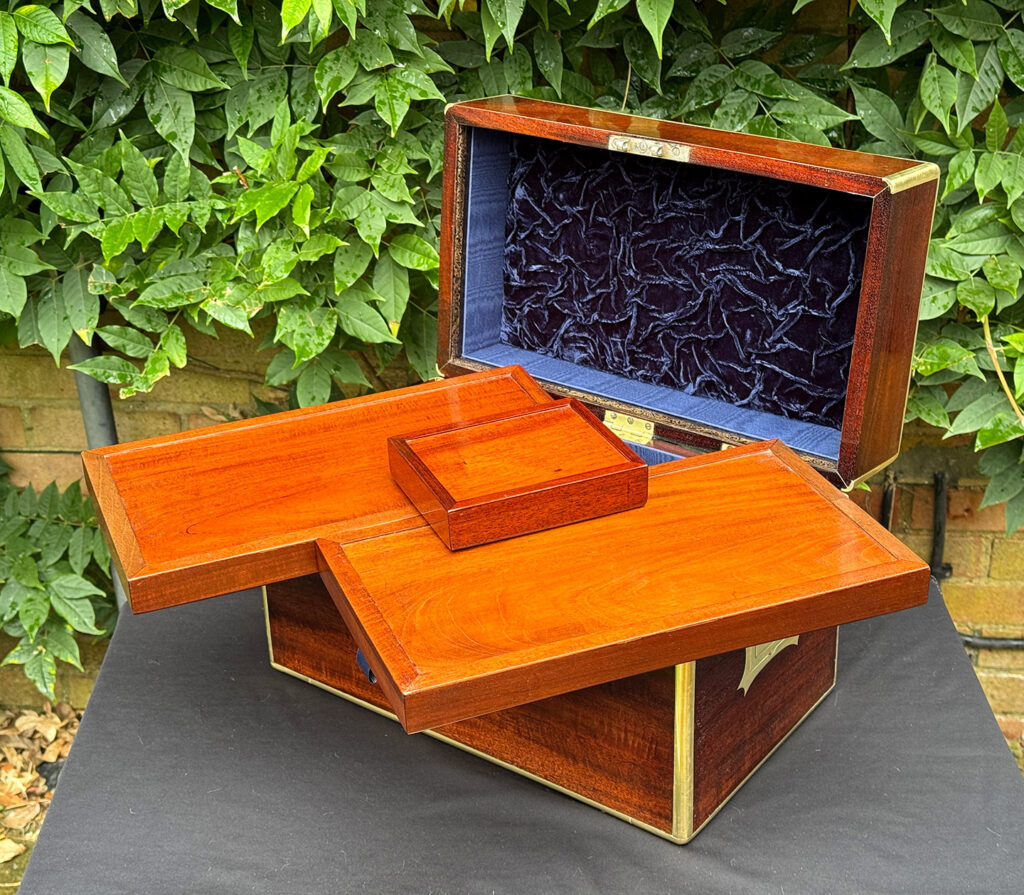 View of the underside of the trays from a large antique gentleman’s travelling jewellery box in Cuban mahogany.