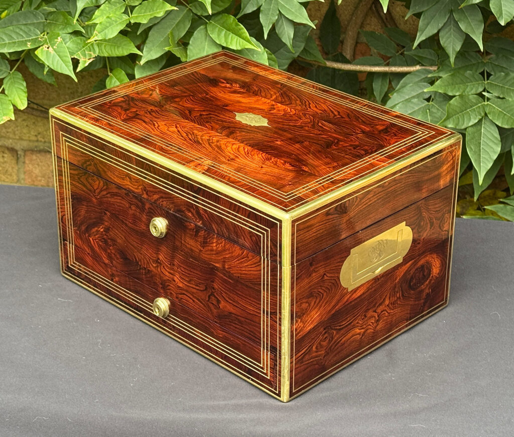 Front right view of an antique jewellery box in kingwood, by Halstaff & Hannaford.