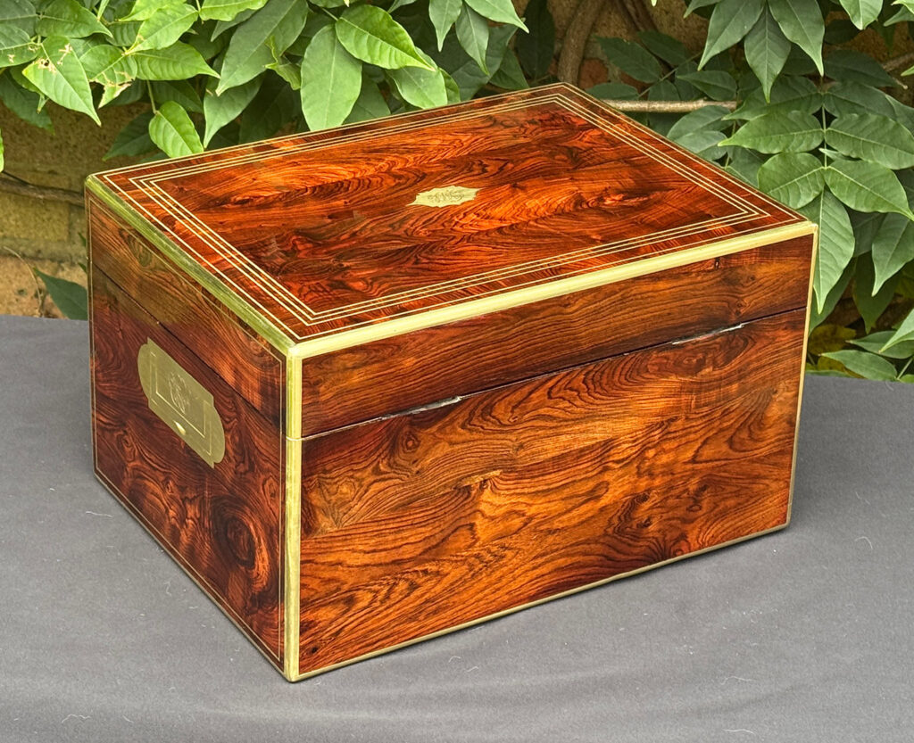 Rear right view of an antique jewellery box in kingwood, by Halstaff & Hannaford.