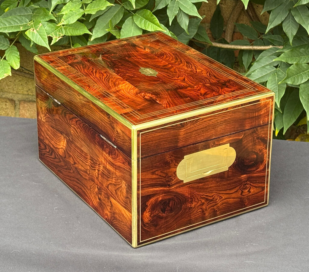 Rear left view of an antique jewellery box in kingwood, by Halstaff & Hannaford.