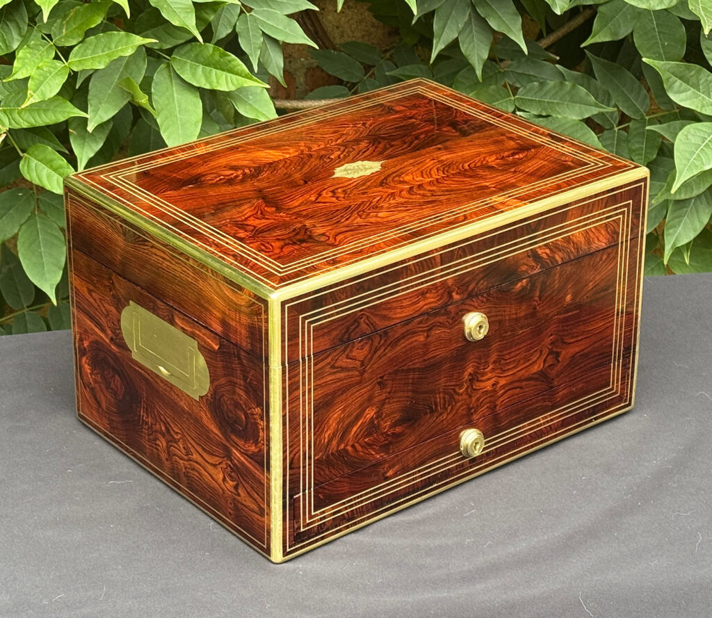Front left view of an antique jewellery box in kingwood, by Halstaff & Hannaford.
