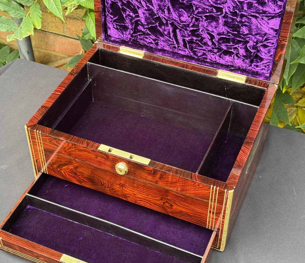 Overhead internal view of an antique jewellery box in kingwood, by Halstaff & Hannaford with tray removed.