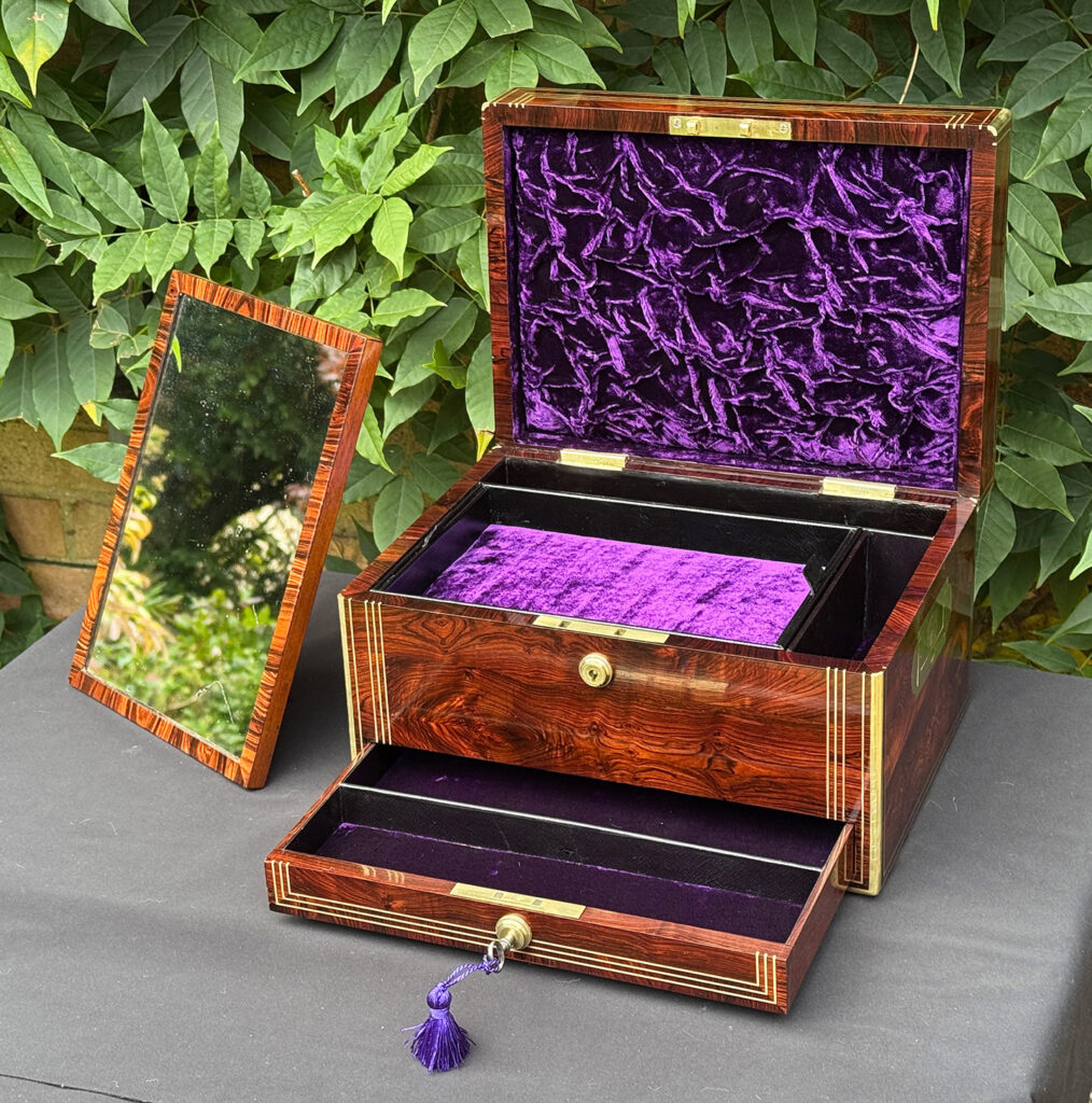 Front internal view of an antique jewellery box in kingwood, by Halstaff & Hannaford with freestanding mirror removed.