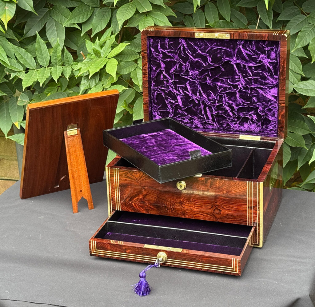 Front internal view of an antique jewellery box in kingwood, by Halstaff & Hannaford with freestanding mirror removed and reversed.