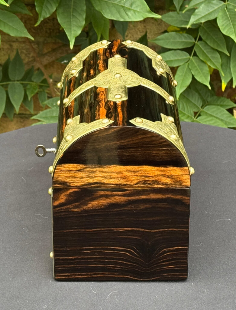 Right side view of an antique jewellery box in coromandel with engraved brass overlay.