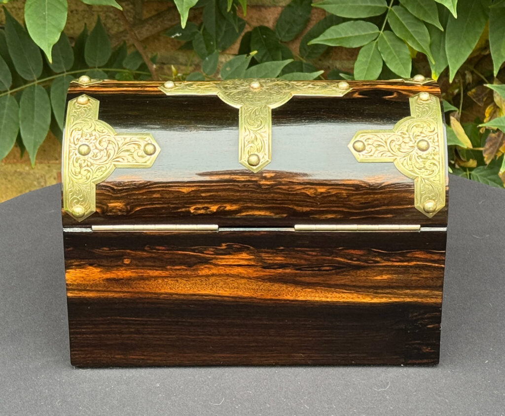 Rear view of an antique jewellery box in coromandel with engraved brass overlay.