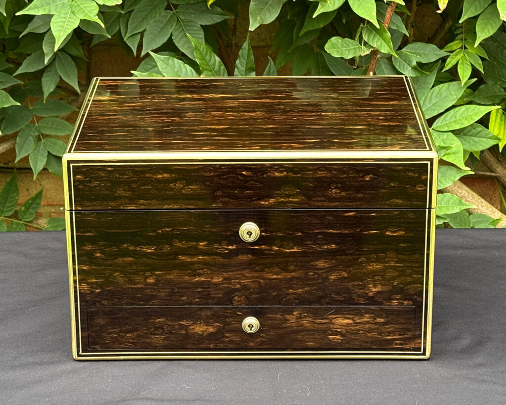 Front view of an antique jewellery box in coromandel, by Charles Asprey.