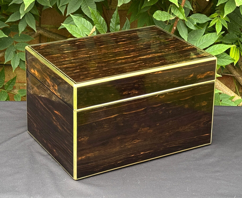 Rear right view of an antique jewellery box in coromandel, by Charles Asprey.
