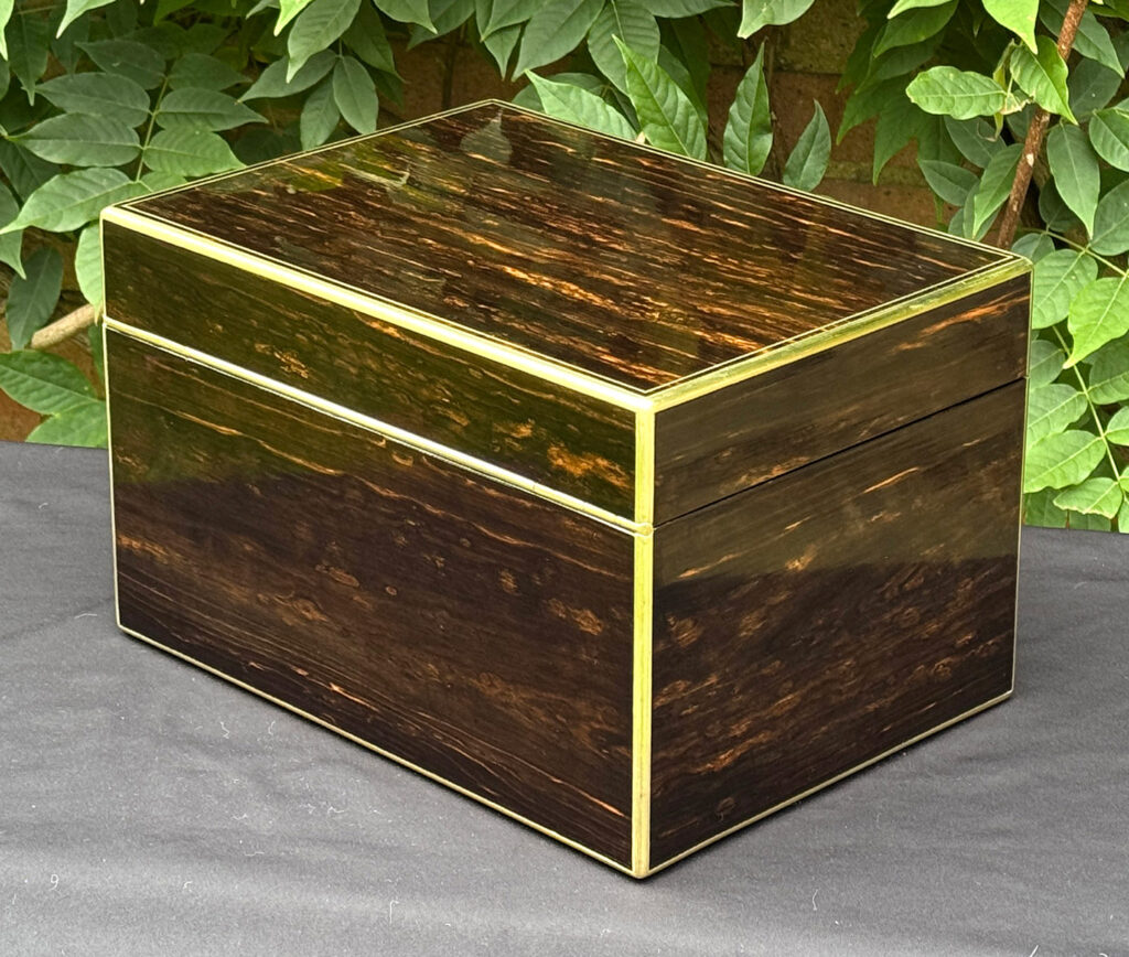 Rear left view of an antique jewellery box in coromandel, by Charles Asprey.