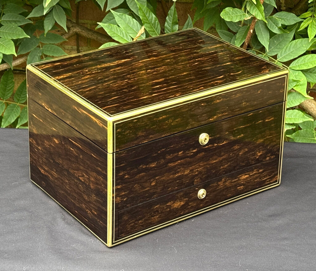 Front left view of an antique jewellery box in coromandel, by Charles Asprey.