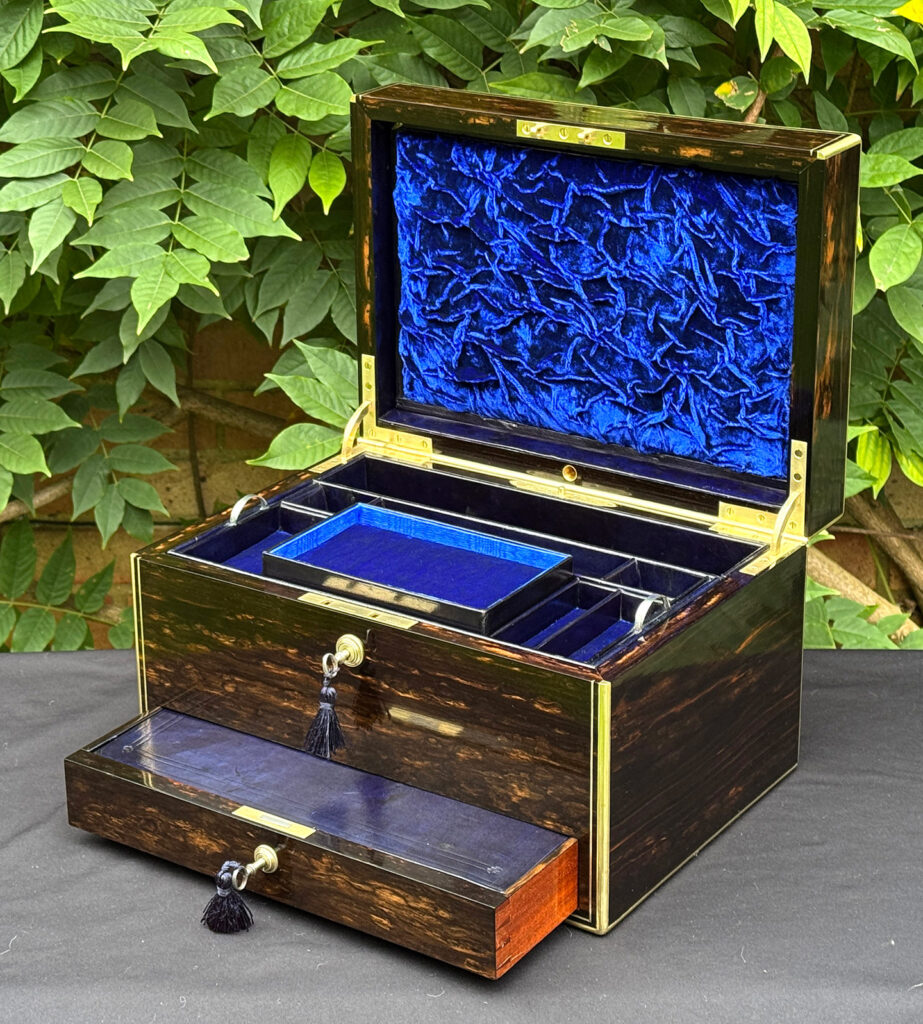 Front right internal view of an antique jewellery box in coromandel, by Charles Asprey.