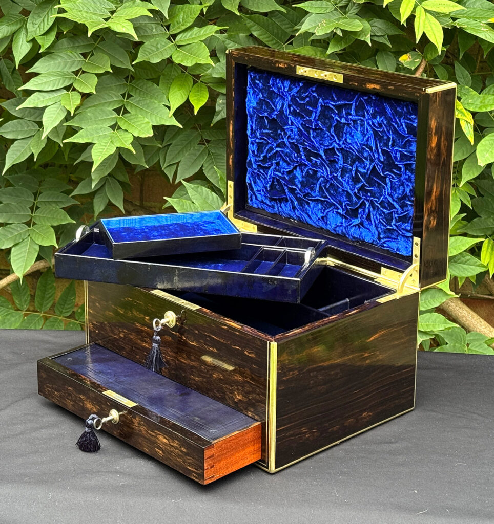 Front right internal view of an antique jewellery box in coromandel, by Charles Asprey, with trays removed.