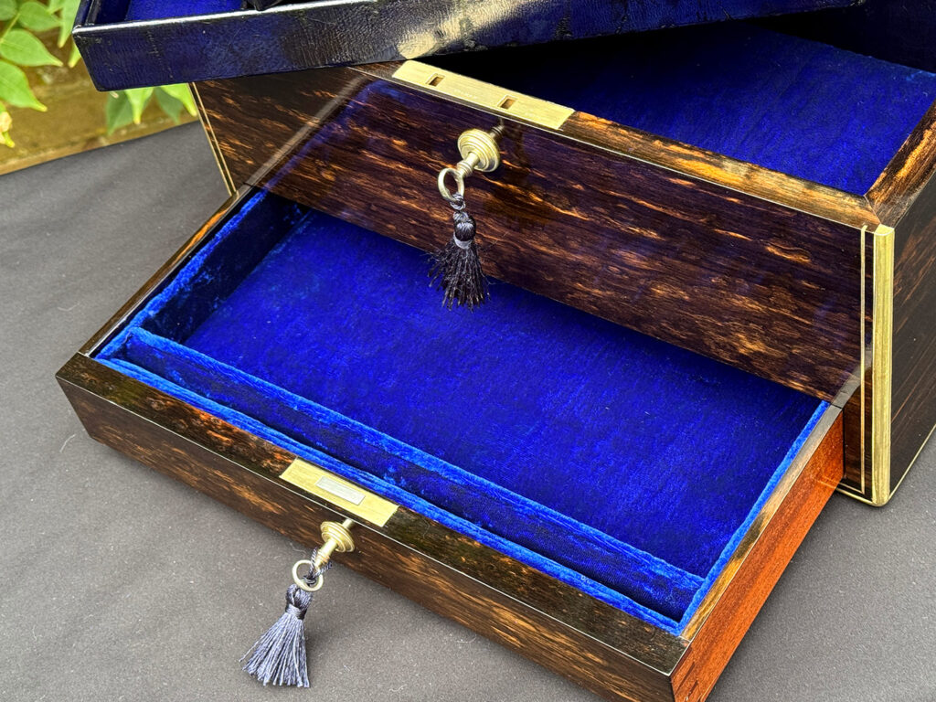 Close up view of the lower drawer from an antique jewellery box in coromandel, by Charles Asprey.