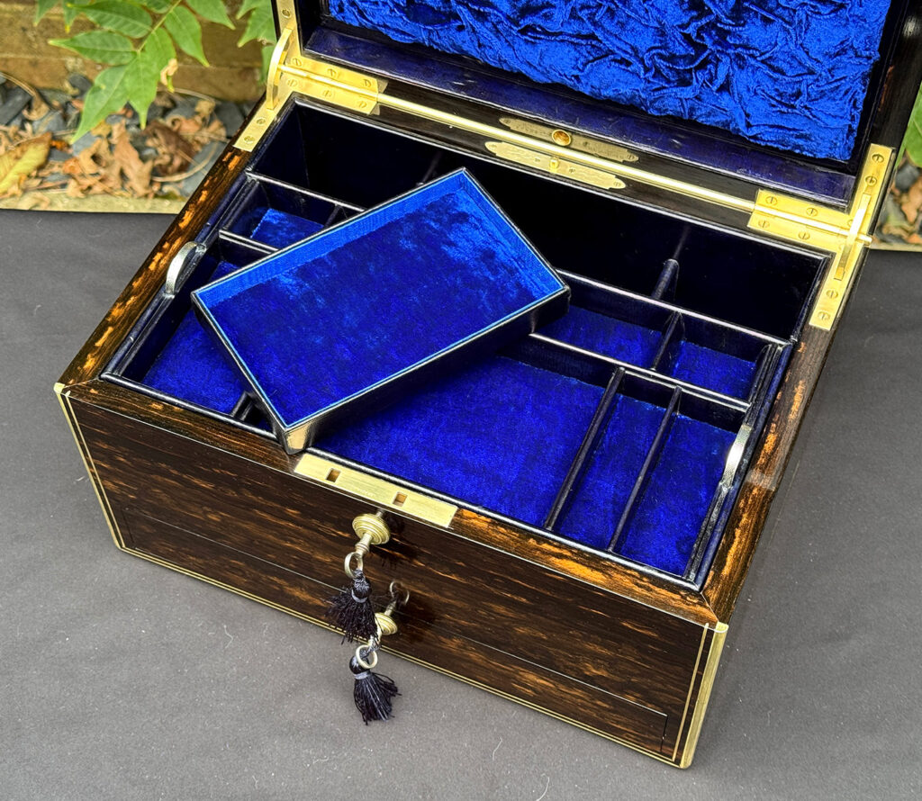 Close up view of the removed sub-tray from an antique jewellery box in coromandel, by Charles Asprey.