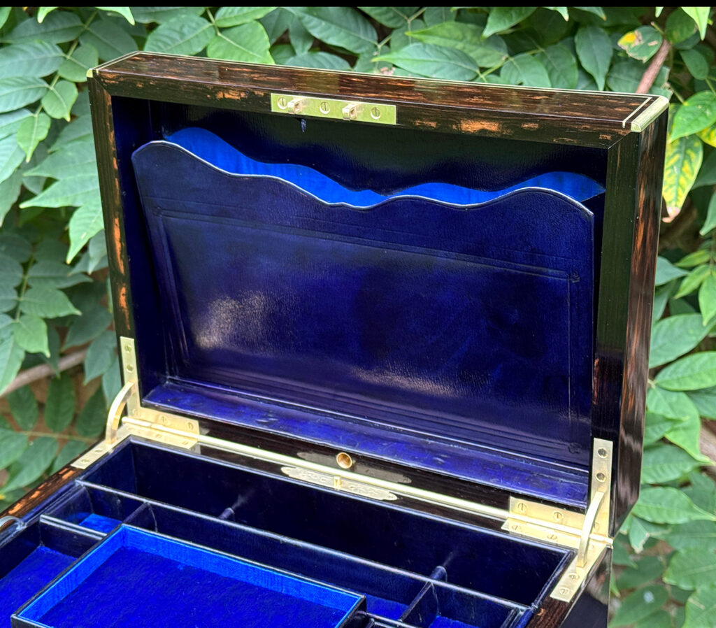 Internal view of the concealed letter wallet from an antique jewellery box in coromandel, by Charles Asprey.