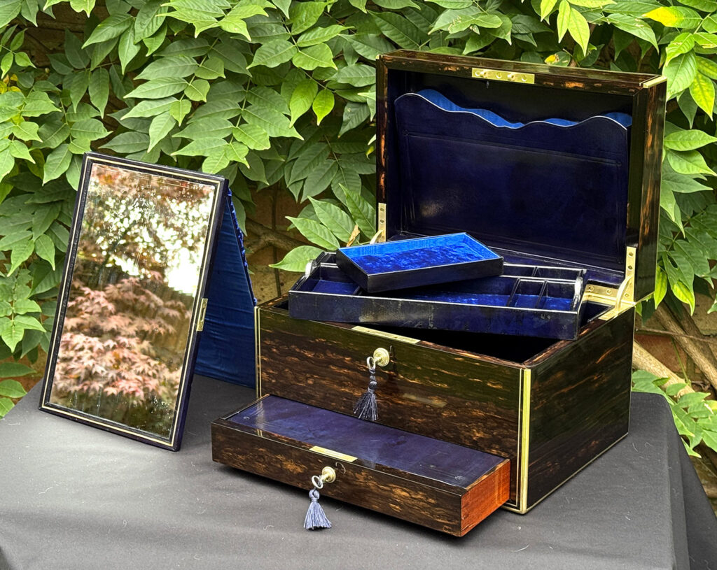 Front internal view of an antique jewellery box in coromandel, by Charles Asprey, with mirror removed.