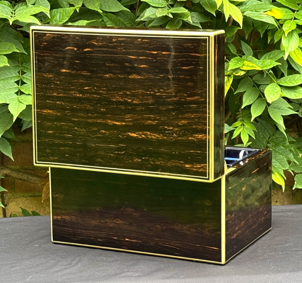 Rear opened view of an antique jewellery box in coromandel, by Charles Asprey.