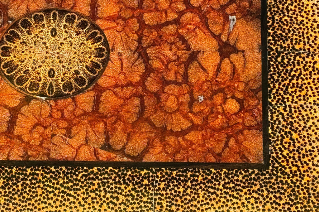 Close up view of the solid chrysanthemum and black palm woods.
