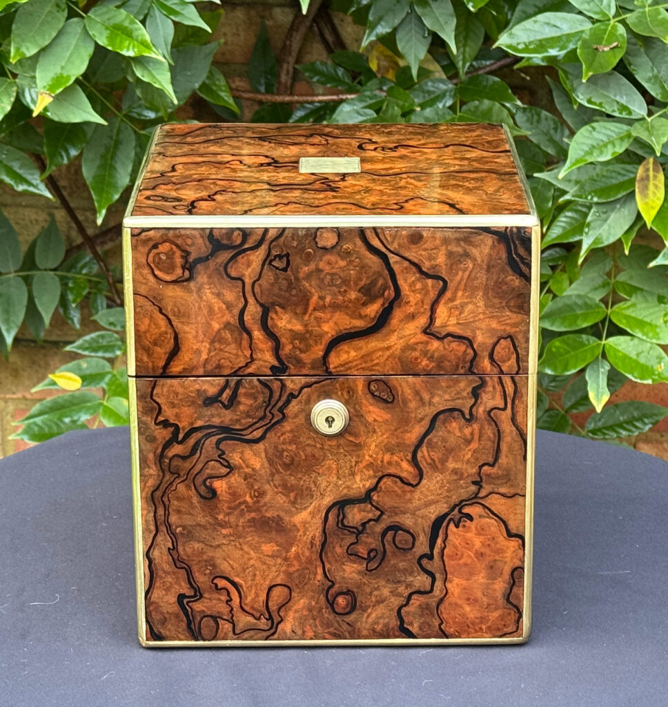 Front view of an antique jewellery box in enhanced burr walnut.