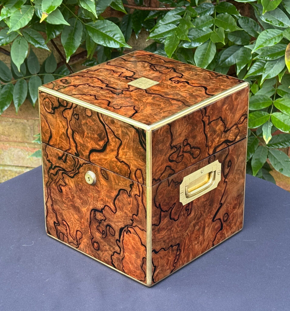 Front right view of an antique jewellery box in enhanced burr walnut.