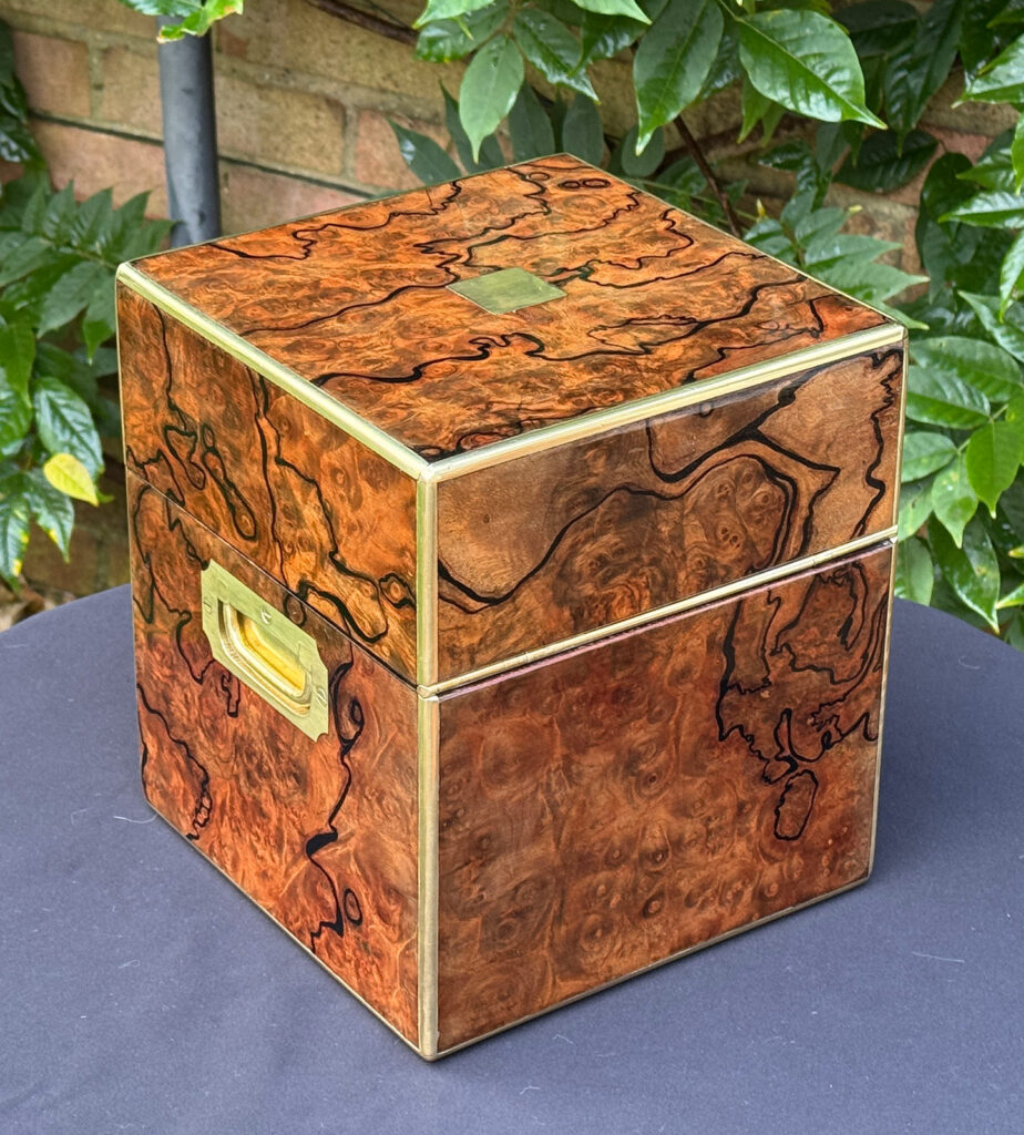 Rear right view of an antique jewellery box in enhanced burr walnut.