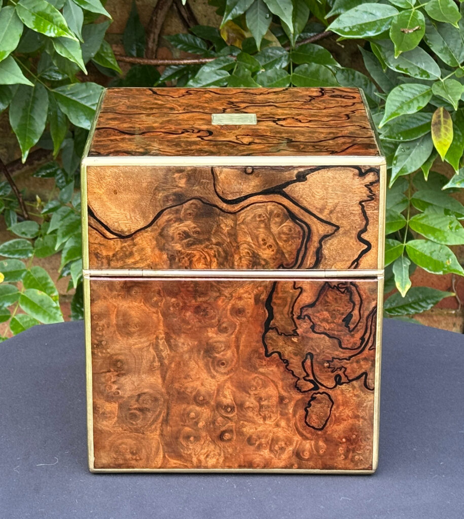 Rear view of an antique jewellery box in enhanced burr walnut.