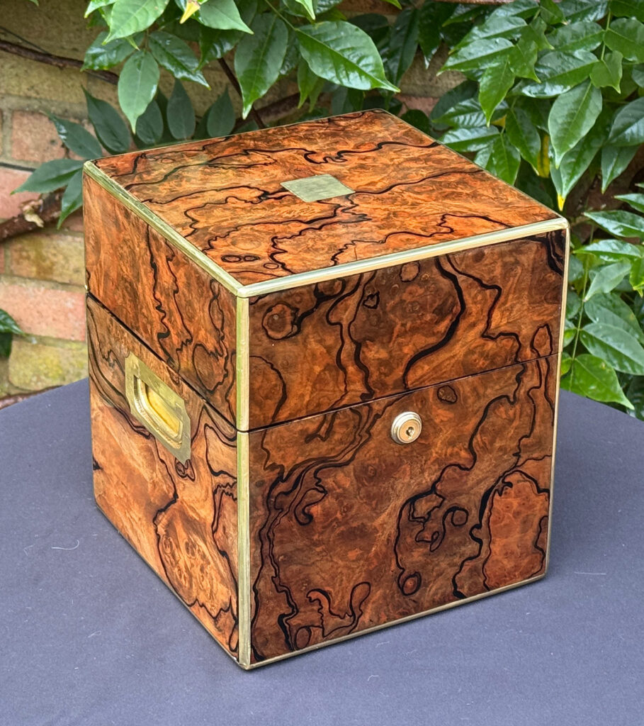 Front left view of an antique jewellery box in enhanced burr walnut.