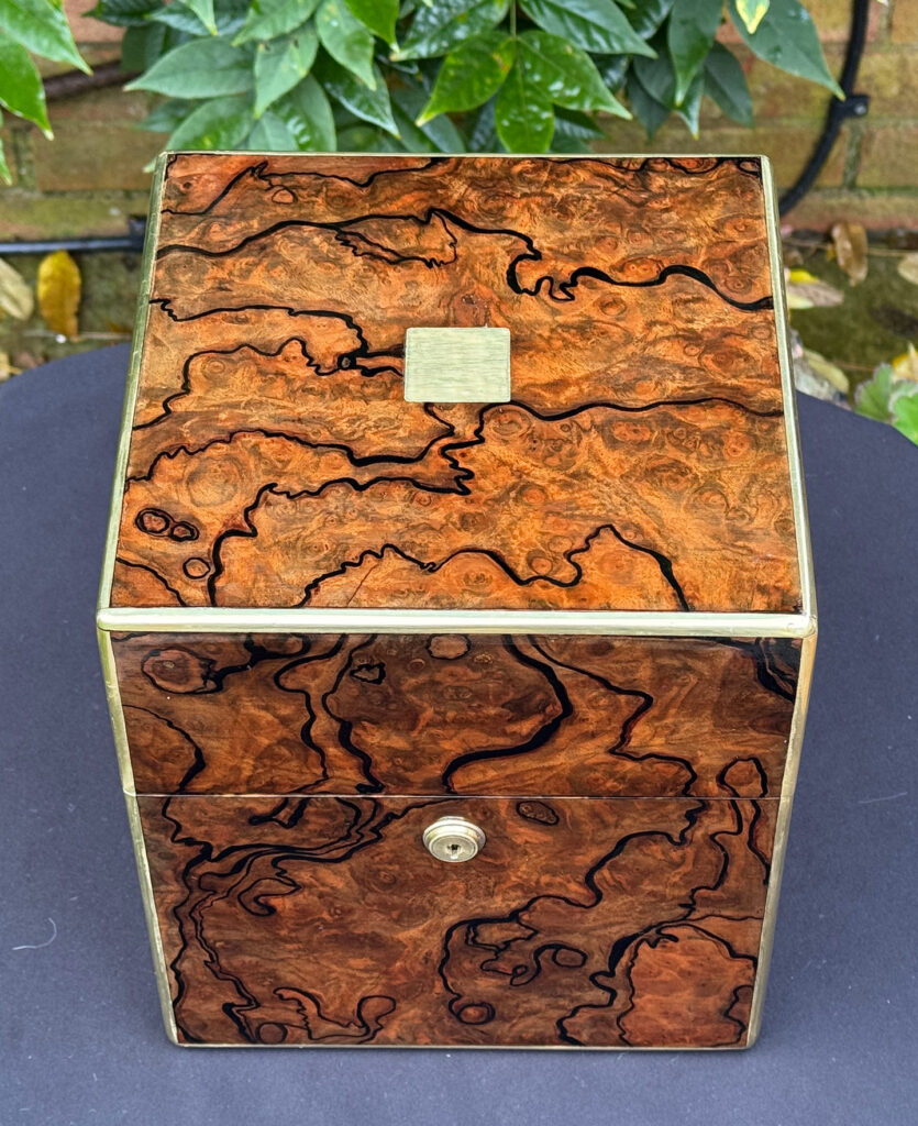 Overhead view of an antique jewellery box in enhanced burr walnut.