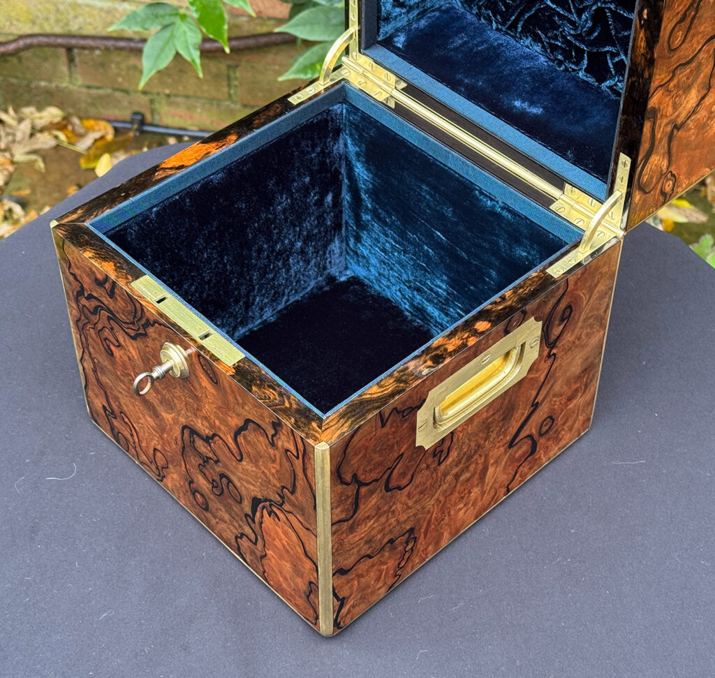 Close internal view of an antique jewellery box in enhanced burr walnut.