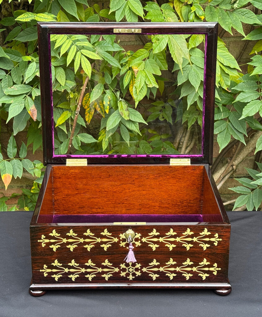 Front internal view of an antique rosewood brass inlaid glass display jewellery box.