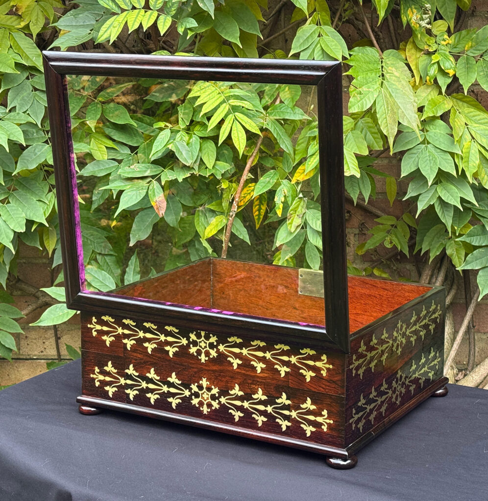 Rear opened view of an antique rosewood brass inlaid glass display jewellery box.