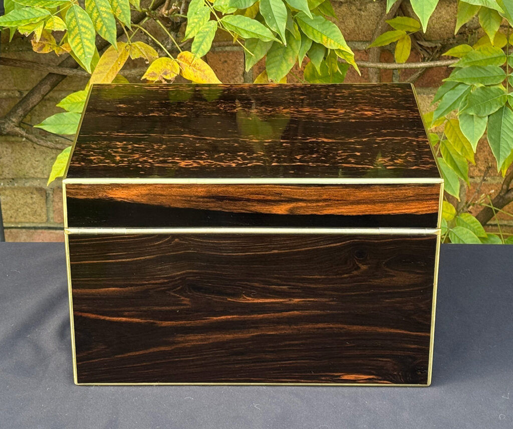 Rear view of an antique jewellery box in coromandel with two concealed drawers.