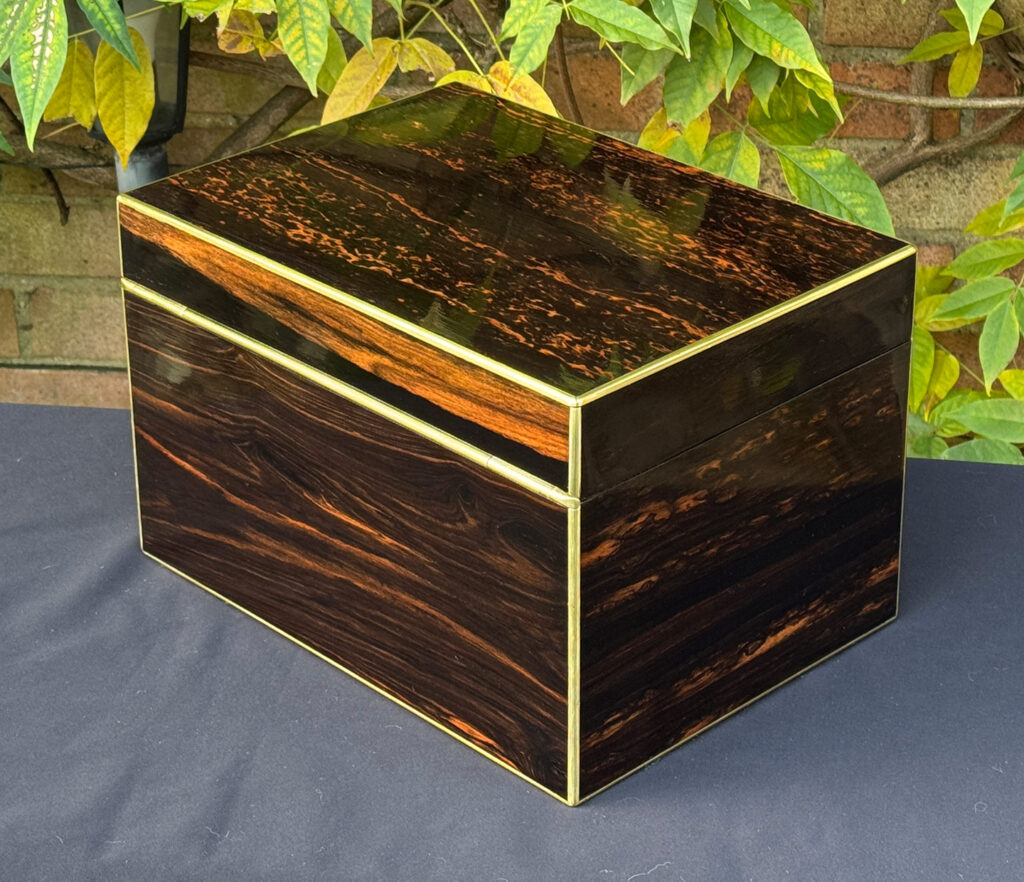 Rear left view of an antique jewellery box in coromandel with two concealed drawers.