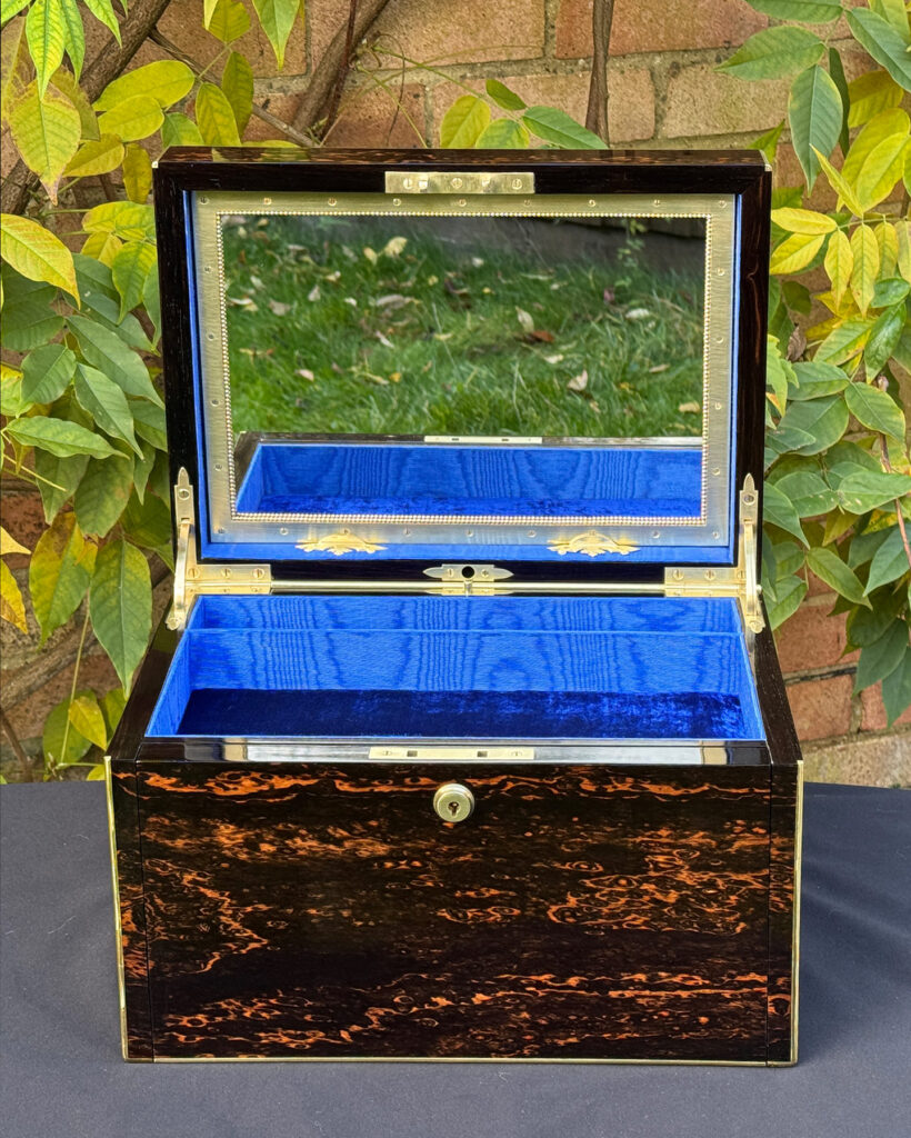 Front internal view of an antique jewellery box in coromandel with two concealed drawers.