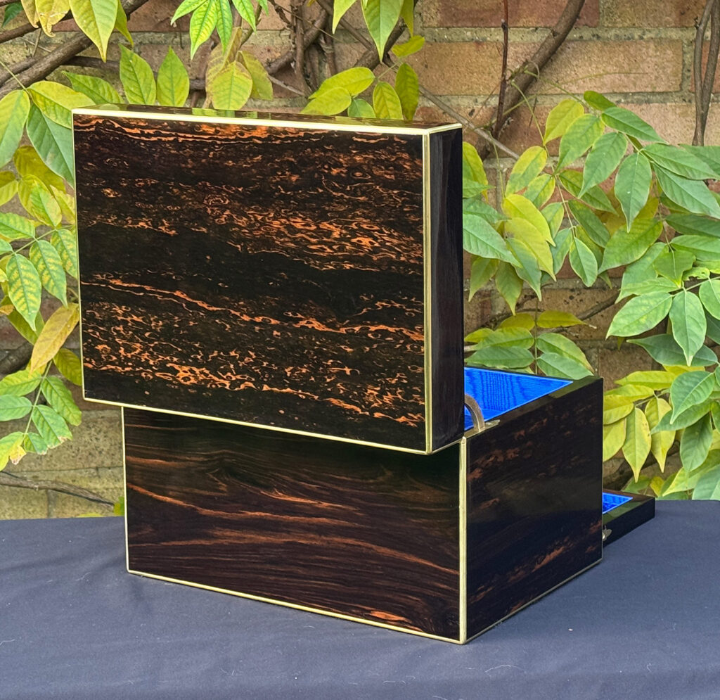 Rear opened view of an antique jewellery box in coromandel with two concealed drawers.