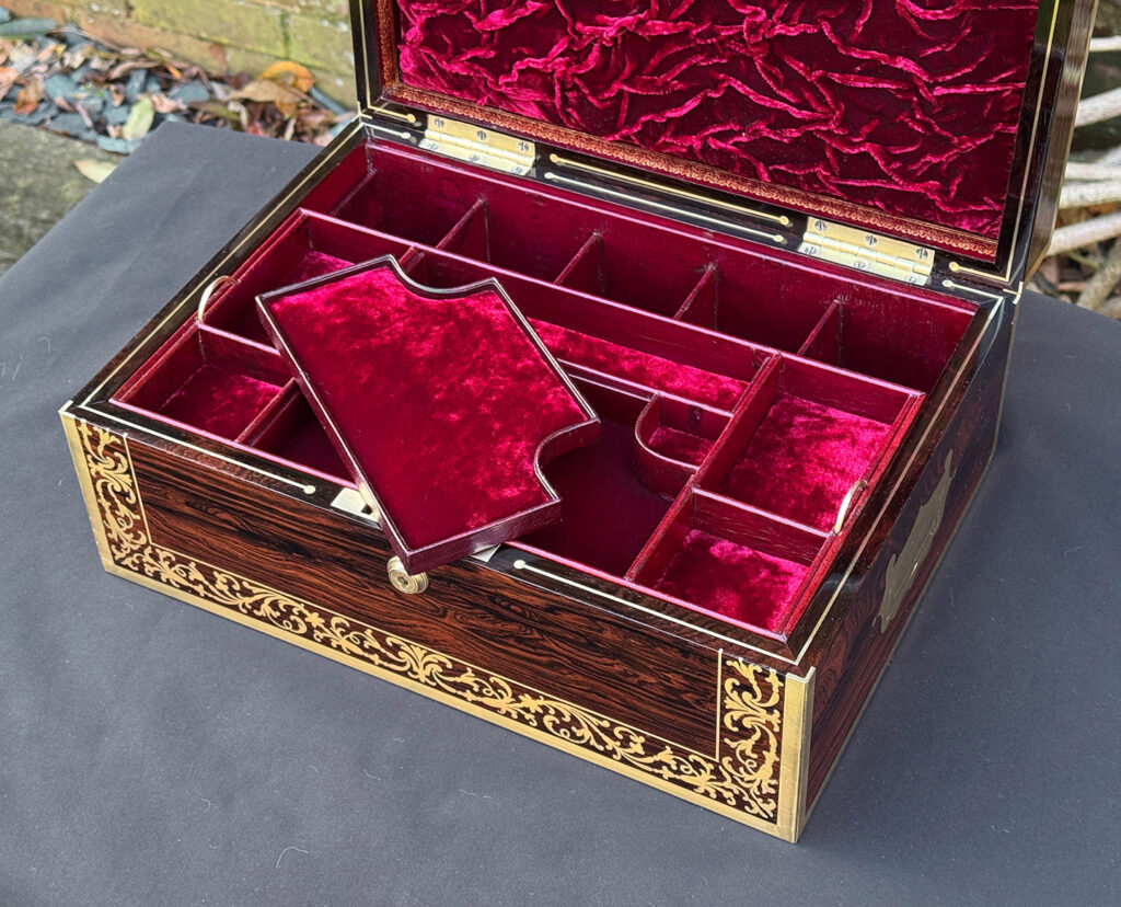 Overhead internal view of an antique jewellery box in Rosewood with scrollwork brass inlay, by Edwards.