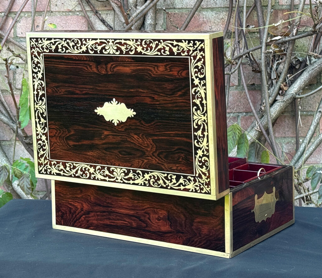 Rear opened view of an antique jewellery box in Rosewood with scrollwork brass inlay, by Edwards.